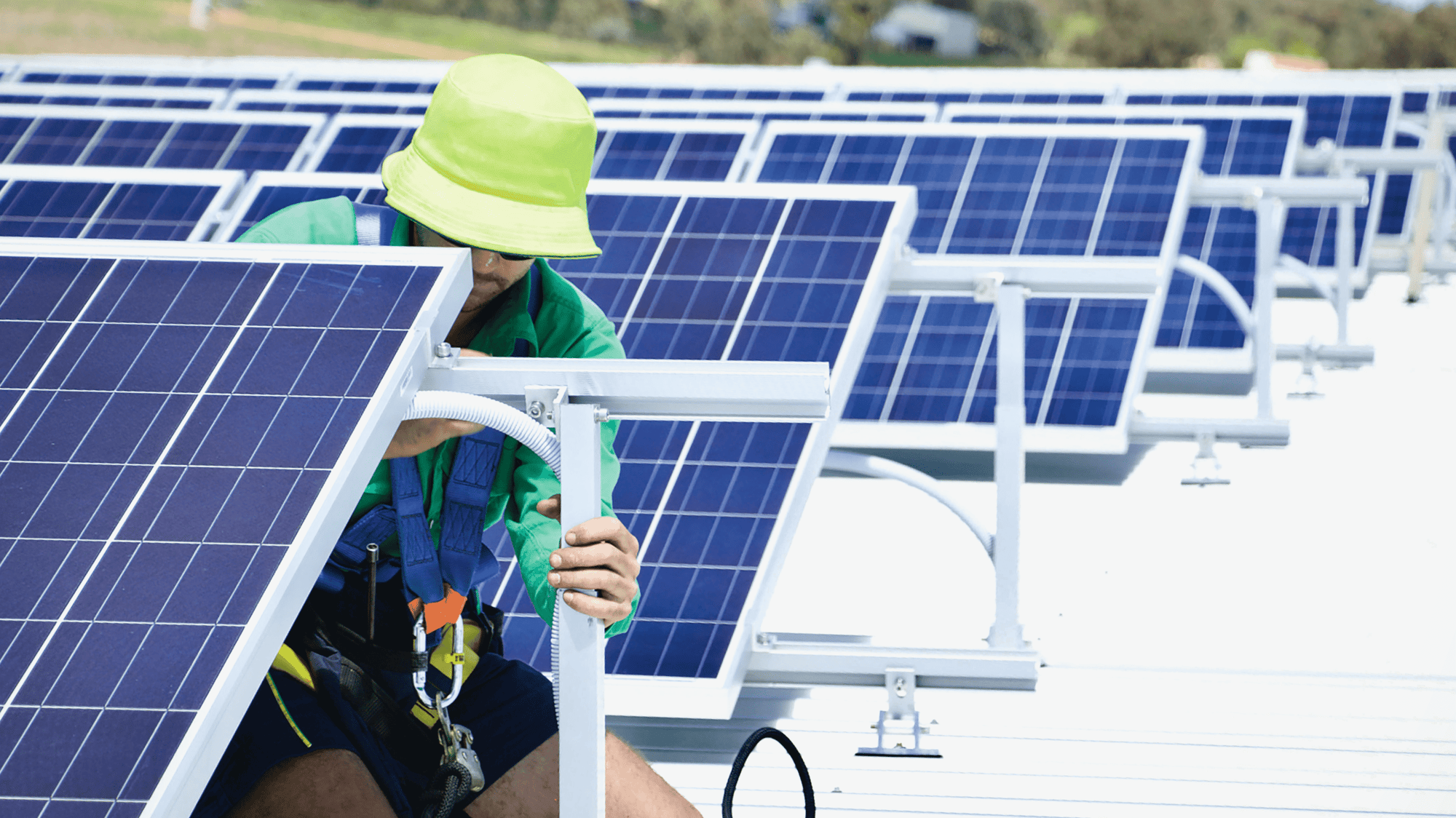 Smart Commercial Solar panel maintenance technician performing ground-level solar panel maintenance