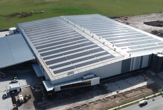 Aerial view of rooftop solar panels on a warehouse