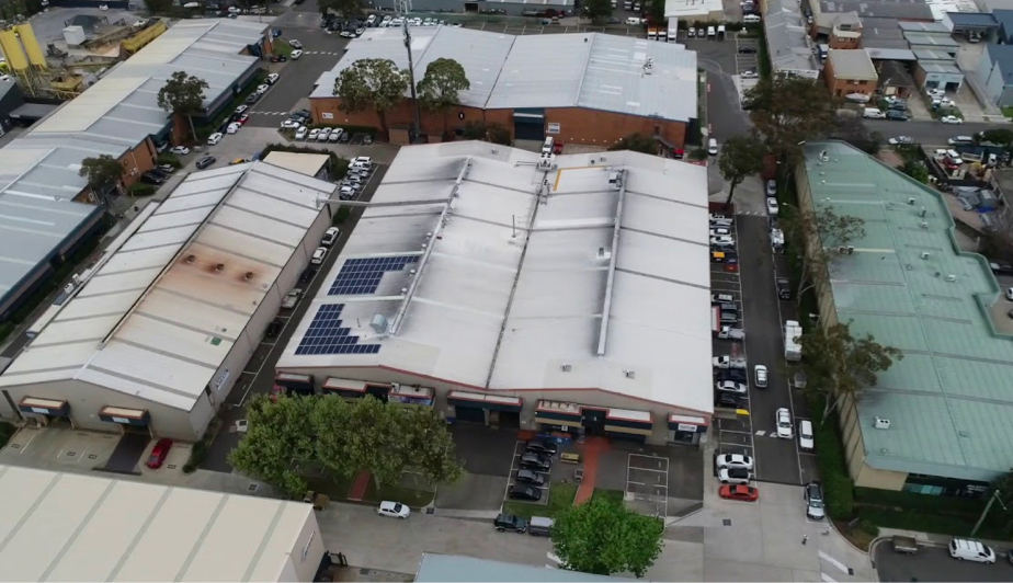 An aerial perspective of a sprawling industrial facility with solar panels