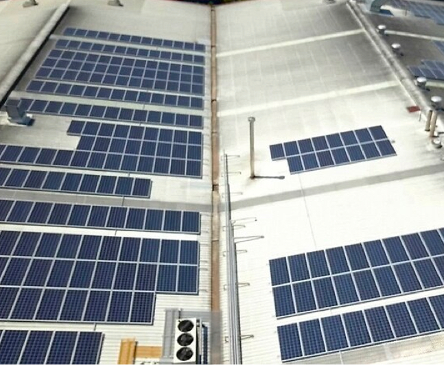 Sustainable energy source with solar panels on building rooftop