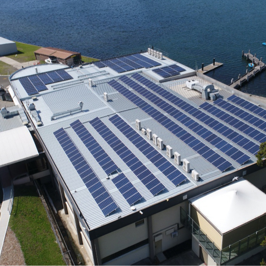 Arial view of solar panels on a rooftop - illustrating our approach to designing commercial solar systems based on energy consumption, available space, and financial returns